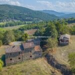 Aerial view of fixer upper farmhouse and barn in Umbria