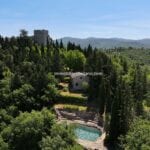 View of Tuscan castle in Italy and pool