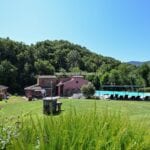 View of historic Tuscan mill complex and pool