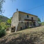 External view of home in Umbria needing renovation.