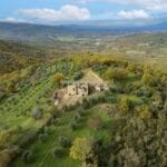 View of land and farmhouse with outbuildings. All needing renovation. Bucine Tuscany Italy