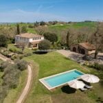 View of luxury villa in the country, pool and gardens, Buonconvento Tuscany Italy