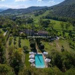 View of Historic Italian home showing farmhouse, church, pool and gardens near Umbertide Umbria