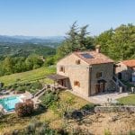 View of restored farmhouse home with pool and garden Anghiari Tuscany Italy