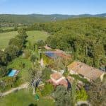 View of buildings, pool and land Siena Tuscany Italy horse property