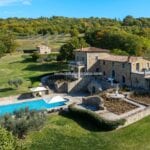 View of buildings and pool on a Luxury Italian estate Lisciano Niccone Perugia Umbria