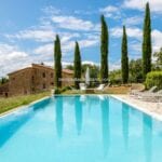 View of pool and luxury farmhouse home Siena Tuscany Italy