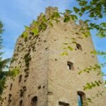 External view of restored medieval tower for sale near Rimini Emilia Romagna Italy.