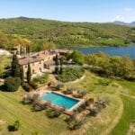 View of restored hamlet, pool, gardens and fantastic views of Lake Montedoglio Anghiari Tuscany Italy