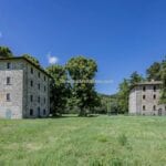 View showing houses for sale with gardens and hot spring. Apecchio Marche Italy