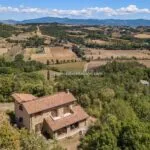 View of farmhouse and surrounding landscape