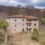 View of Tuscan fixer upper farmhouse