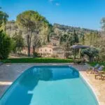Pool view looking at boutique hotel in Tuscany.