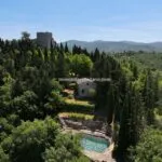 View of Tuscan castle in Italy and pool