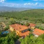 View of buildings, pool and land on Tuscan estate
