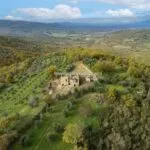 View of land and farmhouse with outbuildings. All needing renovation. Bucine Tuscany Italy