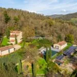 View of country home and buildings, garden and pool in Tuscany Italy