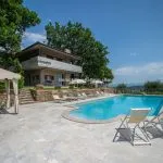 View of pool and modern villa home, Sinalunga Tuscany Italy