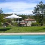 View of pool and Tuscan mill home