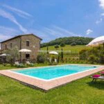 View of main farmhouse with pool in Tuscany