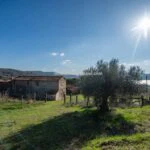 View of farmhouse and lake in Umbria