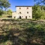 External view of typical farmhouse in Tuscany, needing renovation.