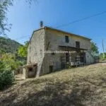 External view of home in Umbria needing renovation.