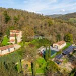 View of country home and buildings, garden and pool in Tuscany Italy