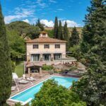 View of pool and luxury villa in Tuscany