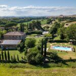 View of pool and Tuscan agriturismo
