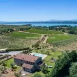 View of Italian farmhouse home and Lake Trasimeno Umbria