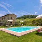 View of main farmhouse with pool in Tuscany