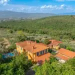 View of buildings, pool and land on Tuscan estate
