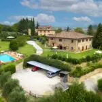 View of Tuscan farmhouse with San Gimagnano in the background