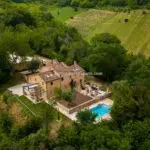 Aerial view of lovely Marche Italy country home with pool and gardens.