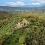 View of land and farmhouse with outbuildings. All needing renovation. Bucine Tuscany Italy