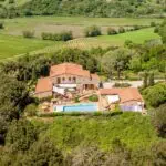 Aerial view show Tuscan resort, buildings, pool and landscape