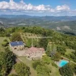 Aerial view of farm, farmhouses, pool and land at Caprese Michelangelo Tuscany Italy